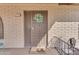 Close-up of the front door entrance featuring a wreath, security door, and 'hello' welcome mat at 4720 E Flossmoor Cir, Mesa, AZ 85206