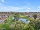 Aerial view of a lush golf course with a pond at 4720 E Flossmoor Cir, Mesa, AZ 85206