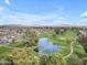 Beautiful golf course with a pond and green fairways amid a residential area at 4720 E Flossmoor Cir, Mesa, AZ 85206