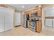 Functional kitchen with stainless steel appliances, wood cabinetry, and tile floors at 4720 E Flossmoor Cir, Mesa, AZ 85206