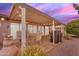 Covered patio with comfortable seating and a grill, perfect for outdoor entertaining in the evening at 4720 E Flossmoor Cir, Mesa, AZ 85206