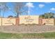 Welcome sign to Sunland Village Golf Club, with a brick base and manicured landscaping at 4720 E Flossmoor Cir, Mesa, AZ 85206