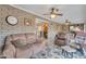 Relaxing sun room with brick walls, tile floor, ceiling fans, and comfortable seating arrangement at 4720 E Flossmoor Cir, Mesa, AZ 85206