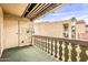 Outdoor balcony showing a door, vintage lamp fixture, decorative railing, and view of the neighboring building at 4950 N Miller Rd # 231, Scottsdale, AZ 85251