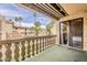 Exterior balcony showcases palm trees and a view of the neighborhood with decorative railings and green flooring at 4950 N Miller Rd # 231, Scottsdale, AZ 85251