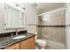 Bathroom with tiled shower with sliding glass door and granite topped vanity at 4950 N Miller Rd # 231, Scottsdale, AZ 85251