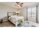 Cozy bedroom with wood floors, ceiling fan, neutral paint and bright, natural light at 4950 N Miller Rd # 231, Scottsdale, AZ 85251