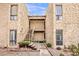 Building exterior showcasing a two-story tan facade with desert landscaping, stairs to the second level, and unit numbers at 4950 N Miller Rd # 231, Scottsdale, AZ 85251