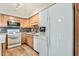 Well-lit kitchen with modern appliances, wooden cabinetry, and a tiled backsplash at 4950 N Miller Rd # 231, Scottsdale, AZ 85251