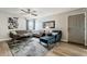 Cozy living room showcasing a sectional sofa, contemporary decor, ceiling fan, an art piece, and wood flooring at 4950 N Miller Rd # 231, Scottsdale, AZ 85251