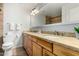 Bathroom featuring a double sink vanity with wooden cabinets and beige countertops at 501 E Hermosa Dr, Tempe, AZ 85282