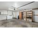 This garage features a laundry area with washer and dryer, built in cabinets, storage shelves, and utility sink at 501 E Hermosa Dr, Tempe, AZ 85282