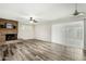 Spacious living room featuring wood-look floors, a cozy fireplace, and sliding glass door at 501 E Hermosa Dr, Tempe, AZ 85282