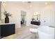 Bright bathroom featuring dual vanities, a soaking tub, and wood-look tile flooring at 510 E Woburn Ln, Phoenix, AZ 85085