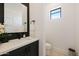 Stylish powder room featuring sleek black fixtures, mosaic tile accent wall, and a modern floating vanity at 510 E Woburn Ln, Phoenix, AZ 85085