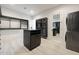 Large walk-in closet with custom cabinets, shelves, and island, and a stacked washer/dryer at 510 E Woburn Ln, Phoenix, AZ 85085