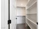 Walk-in closet featuring white shelving, carpeted floor, and ample storage space at 510 E Woburn Ln, Phoenix, AZ 85085