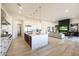 Open-concept kitchen with stainless steel appliances, white cabinets, and a kitchen island at 510 E Woburn Ln, Phoenix, AZ 85085