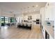 Spacious kitchen featuring white cabinetry, an island with seating, and an open dining area at 510 E Woburn Ln, Phoenix, AZ 85085