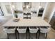 Bright kitchen with large waterfall island, white cabinetry, stainless steel appliances, and stylish pendant lighting at 510 E Woburn Ln, Phoenix, AZ 85085