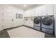 Well-organized laundry room with plenty of cabinetry, stainless steel appliances, and counter space at 510 E Woburn Ln, Phoenix, AZ 85085