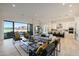 Bright open-concept living room with modern furniture, large sliding glass doors, and views of the backyard at 510 E Woburn Ln, Phoenix, AZ 85085