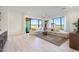 Open living room featuring large windows, a sectional sofa, and light wood-look floors at 510 E Woburn Ln, Phoenix, AZ 85085