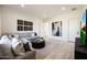 Contemporary living room with neutral decor, stylish gray sofa, modern wall art, and light wood flooring at 510 E Woburn Ln, Phoenix, AZ 85085