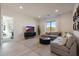 Bright living room featuring neutral tones, an oversized window with mountain views, and an open doorway to the bedroom at 510 E Woburn Ln, Phoenix, AZ 85085