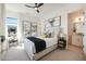 Bright bedroom with modern decor, large windows, black out curtains, and a doorway to the bathroom at 510 E Woburn Ln, Phoenix, AZ 85085