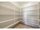 Bright pantry featuring ample storage space with built-in shelving and hardwood floors at 510 E Woburn Ln, Phoenix, AZ 85085