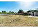 Large backyard with grass, string lights, and a white fence, perfect for outdoor activities and entertaining at 5501 E Camelback Rd, Phoenix, AZ 85018