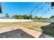 Backyard featuring tile, grass, string lights, and a white fence at 5501 E Camelback Rd, Phoenix, AZ 85018