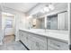 Bathroom with double sinks, white cabinetry, and modern fixtures providing a refreshing and functional space at 5501 E Camelback Rd, Phoenix, AZ 85018