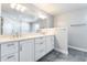 Bright bathroom features double sinks, white cabinets, and sleek tiling at 5501 E Camelback Rd, Phoenix, AZ 85018