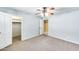 Bedroom with carpet, ceiling fan, white doors and closet with natural light to create a relaxing retreat at 5501 E Camelback Rd, Phoenix, AZ 85018