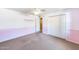 Pink-accented bedroom with carpet, closet, and bathroom access at 5501 E Camelback Rd, Phoenix, AZ 85018