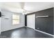 A gray bedroom with a ceiling fan and a window that offers natural light at 5501 E Camelback Rd, Phoenix, AZ 85018