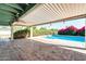 Covered patio with tiled floor overlooking a pool and garden, providing a perfect blend of indoor/outdoor living at 5501 E Camelback Rd, Phoenix, AZ 85018