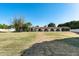 Spacious lawn featuring an single-story home with a red tile roof and an arched walkway at 5501 E Camelback Rd, Phoenix, AZ 85018