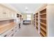 Home office featuring carpet, built-in wooden desk, cabinets, and shelving, along with lots of storage space at 5501 E Camelback Rd, Phoenix, AZ 85018