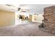 Open-concept living area with tile floors, a stone fireplace, and a seamless transition to the kitchen at 5501 E Camelback Rd, Phoenix, AZ 85018