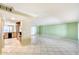 Spacious living room with tile flooring, opening to the kitchen and featuring a bright green accent wall at 5501 E Camelback Rd, Phoenix, AZ 85018