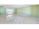 Living room with large ceramic tile, light green walls and a glass door to another room at 5501 E Camelback Rd, Phoenix, AZ 85018