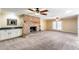 Cozy living room featuring a stone fireplace, a wet bar, plush carpeting, and bright lighting at 5501 E Camelback Rd, Phoenix, AZ 85018