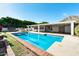 Inviting backyard pool surrounded by lush greenery and a covered patio, creating a private oasis at 5501 E Camelback Rd, Phoenix, AZ 85018