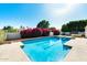 Backyard pool with blooming shrubs adding beauty to the outdoor space at 5501 E Camelback Rd, Phoenix, AZ 85018