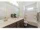 Bright bathroom with dual sinks, modern fixtures, and a combined tub and shower, and tile flooring at 5508 N 192Nd Ave, Litchfield Park, AZ 85340