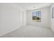 Bedroom featuring neutral carpet, white walls and trim, and a window providing ample natural light at 5508 N 192Nd Ave, Litchfield Park, AZ 85340