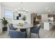 Dining area featuring a modern chandelier, round table, and backyard views at 5508 N 192Nd Ave, Litchfield Park, AZ 85340